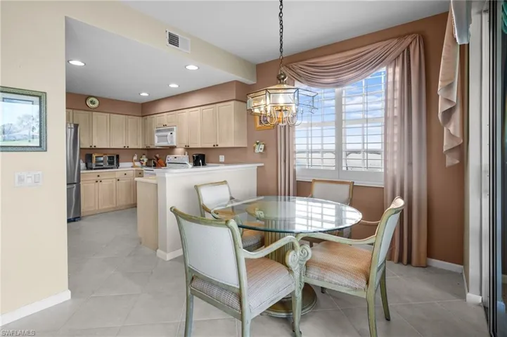 Dining room featuring a chandelier, light tile patterned floors, and recessed lighting