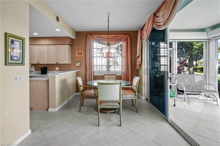 Dining area featuring light tile patterned floors, a chandelier, and recessed lighting