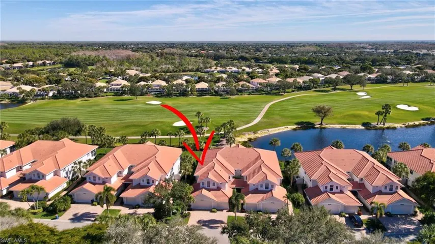 View of property location with a large body of water, a golf course, and nearby suburban area