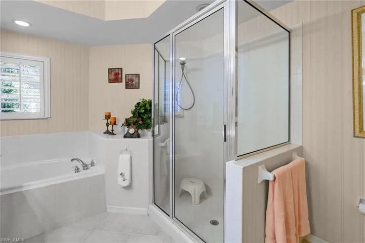 Bathroom featuring wallpapered walls, a bath, a shower stall, tile patterned flooring, and recessed lighting