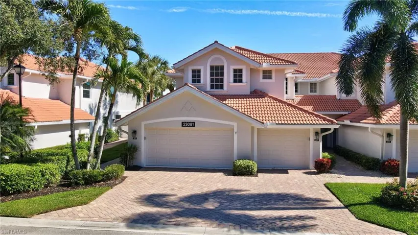 Mediterranean / spanish house with stucco siding, decorative driveway, a tiled roof, and a garage