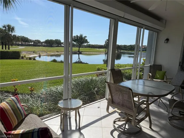 Sunroom / solarium featuring a water view