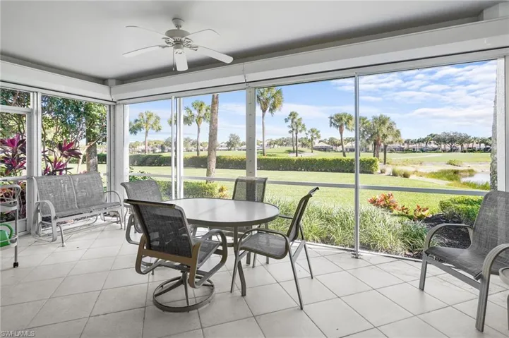 Sunroom / solarium with golf course view and tile patterned flooring