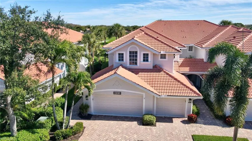 Mediterranean / spanish house with stucco siding, a tile roof, decorative driveway, and a garage