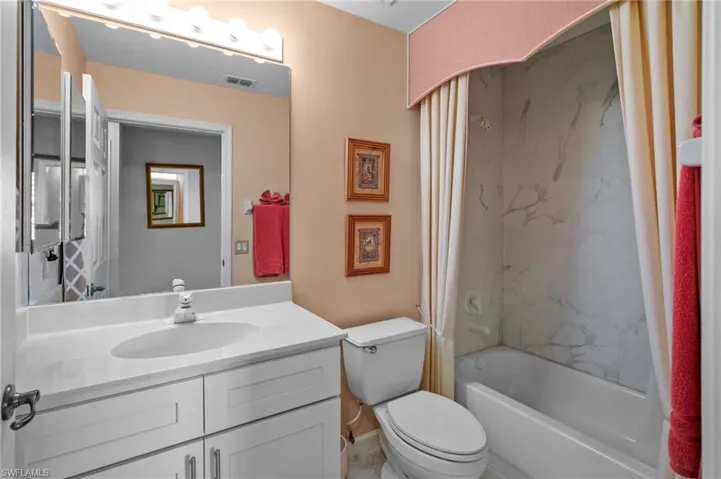 Full bathroom featuring shower / bathtub combination with curtain and vanity