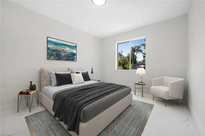 Bedroom with marble finish floors and baseboards