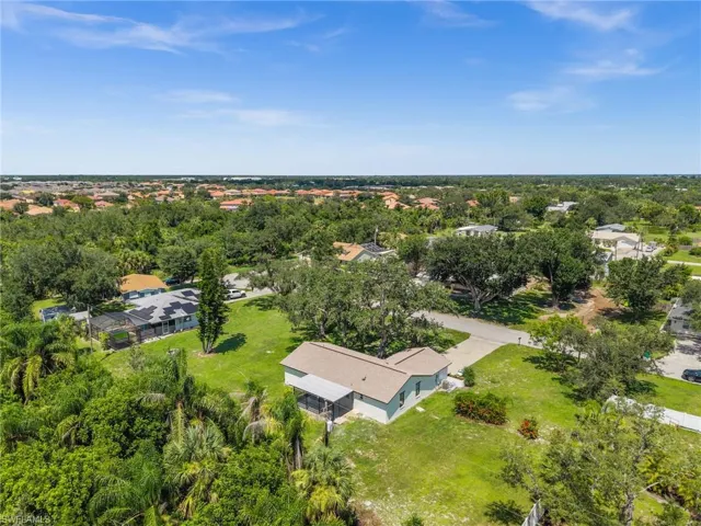 Aerial view of residential area featuring a tree filled landscape