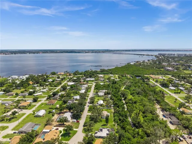 Aerial view of residential area with a notable bridge and a large body of water