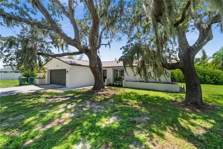 Single story home featuring stucco siding, concrete driveway, and a garage