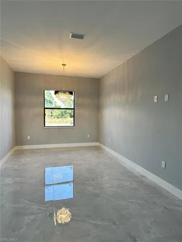 Dining room featuring baseboards and chandelier