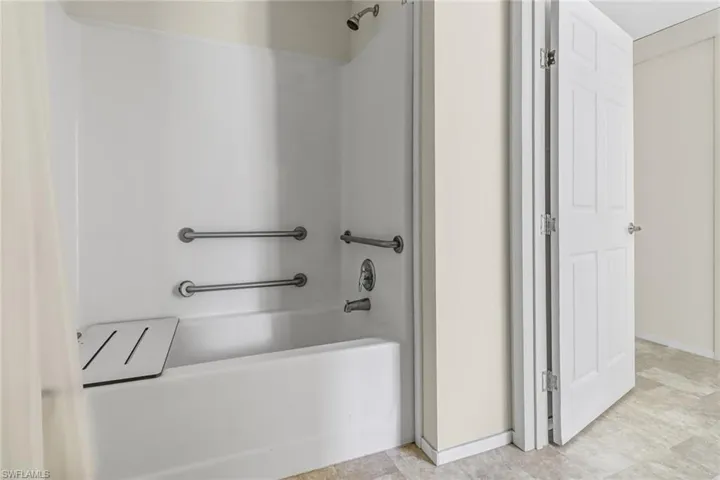 Bathroom featuring tile floors and shower / bathing tub combination