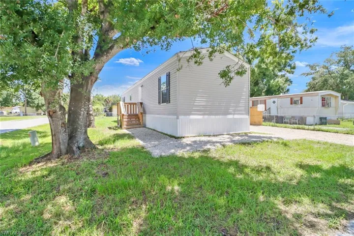 View of side of property featuring a yard