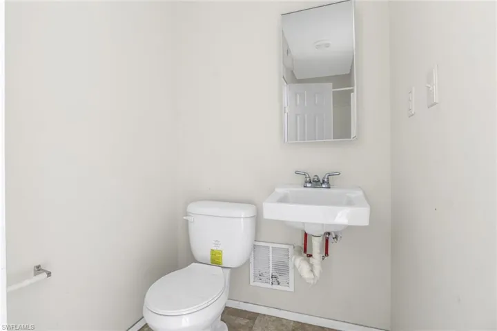 Bathroom with sink, toilet, and tile floors