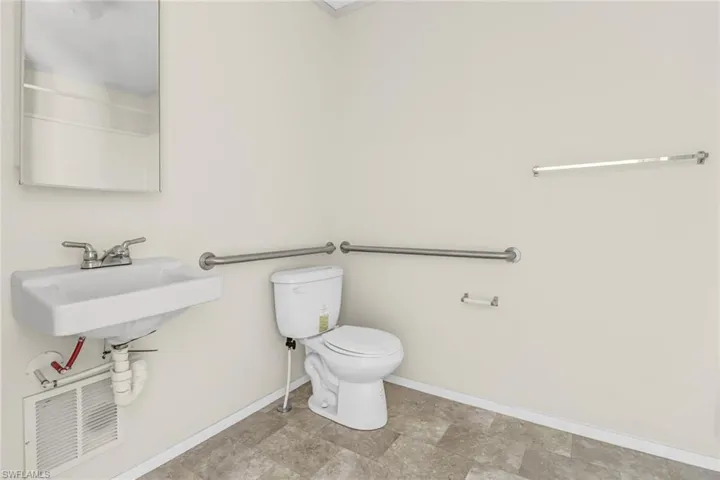 Bathroom featuring tile flooring, sink, and toilet