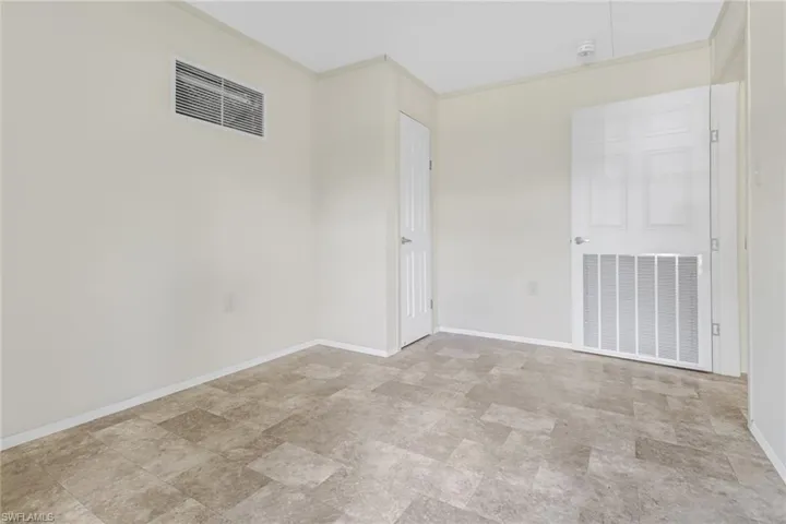 Empty room featuring light tile flooring
