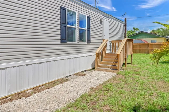 View of property exterior featuring a lawn