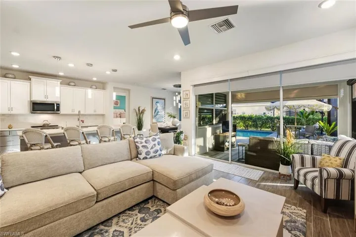 Living area featuring recessed lighting, wood finish floors, and a ceiling fan