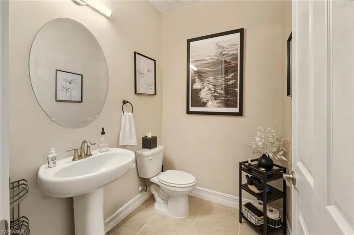 Half bath featuring light tile patterned floors and toilet