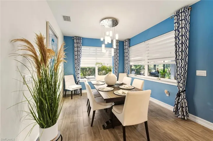 Dining area with wood finish floors and a chandelier