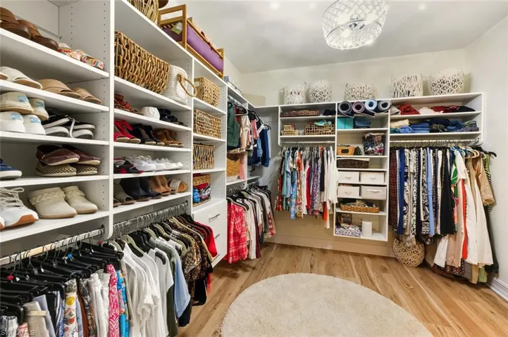 Walk in closet featuring light wood-style flooring