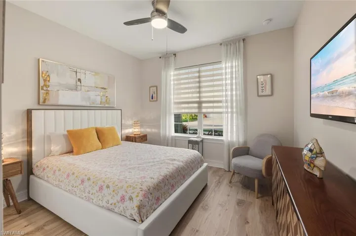 Bedroom with light wood-type flooring and a ceiling fan