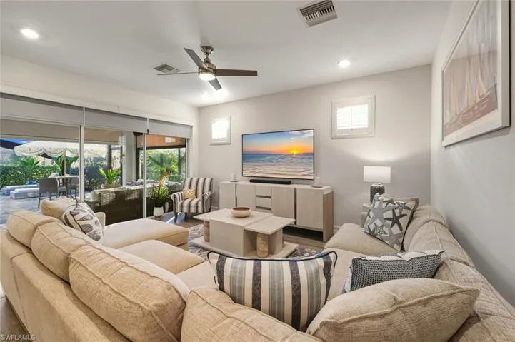 Living area featuring healthy amount of natural light, a ceiling fan, and recessed lighting