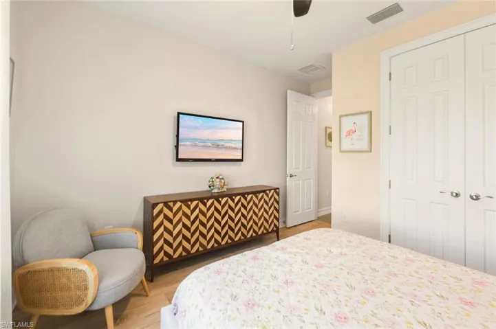 Bedroom with a closet, light wood-type flooring, and ceiling fan