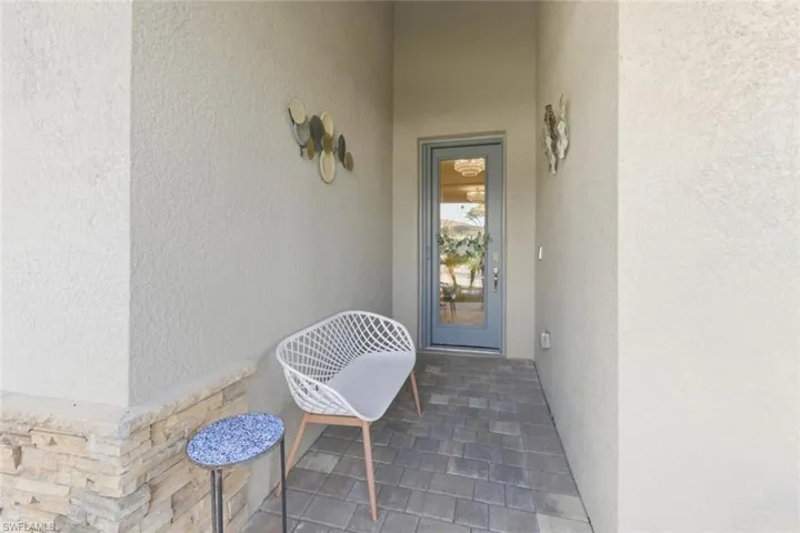 View of exterior entry with stucco siding