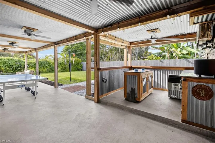 Fenced backyard featuring a ceiling fan and a patio