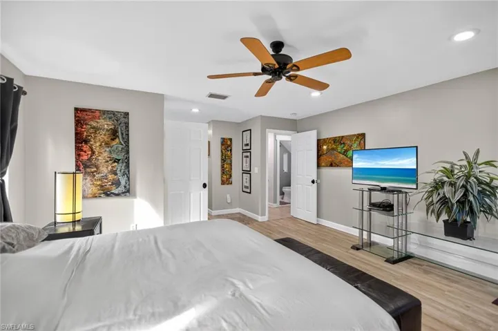 Bedroom featuring light wood-style flooring, ceiling fan, and recessed lighting