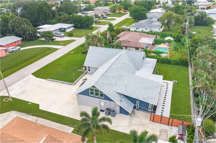 Aerial perspective of suburban area featuring a pool