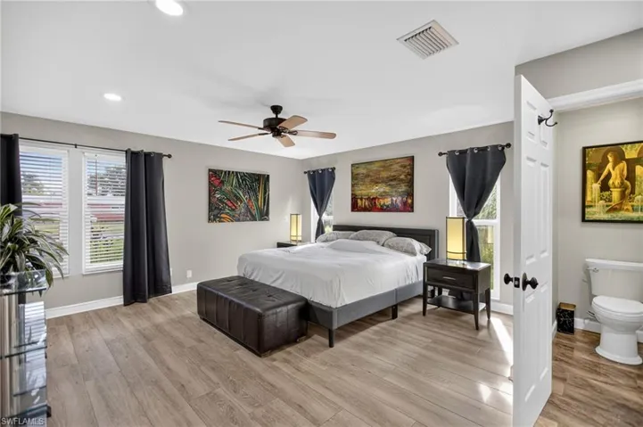 Bedroom featuring light wood-type flooring, a ceiling fan, and recessed lighting