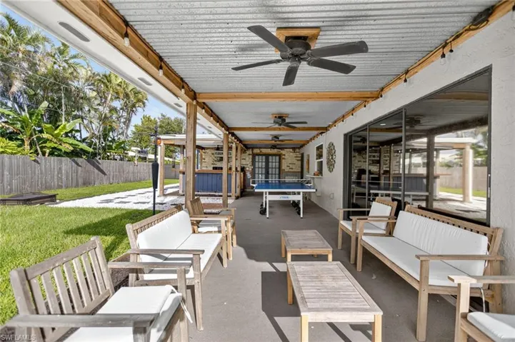 View of patio with an outdoor hangout area, outdoor dining area, and a ceiling fan