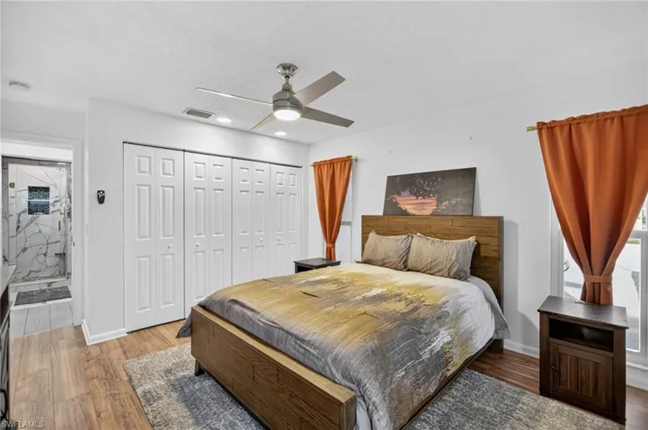Bedroom featuring a closet, wood finished floors, a ceiling fan, and a textured ceiling