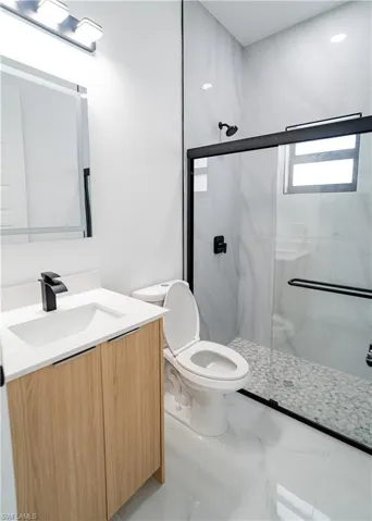 Bathroom with vanity and a stall shower