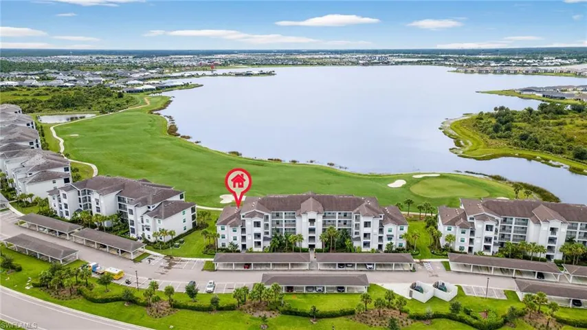 Drone / aerial view of a nearby body of water and a local golf course
