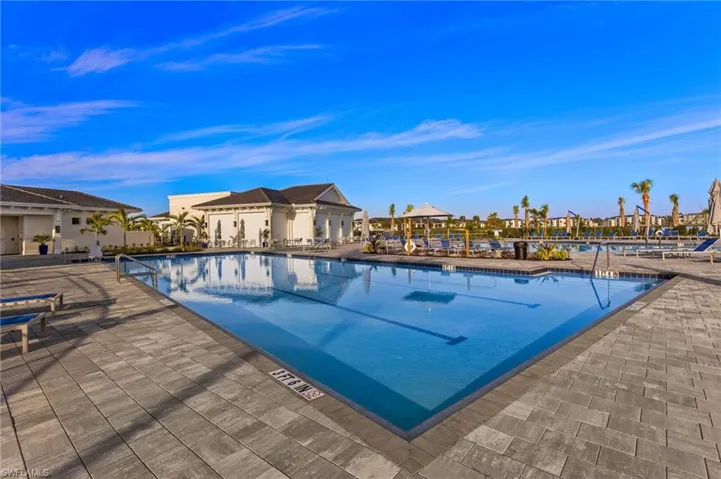 Community pool with a patio