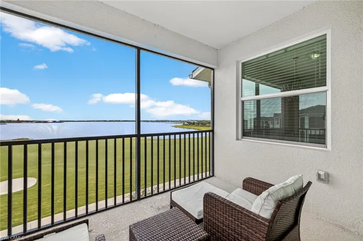 Sunroom / solarium featuring a water view