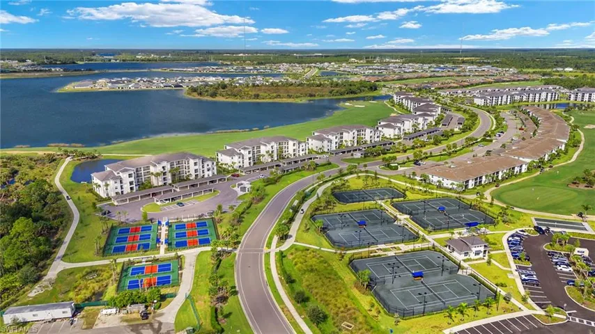 Drone / aerial view of a golf course and a nearby body of water