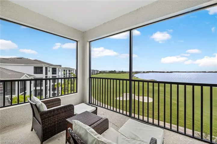 Sunroom featuring a water view