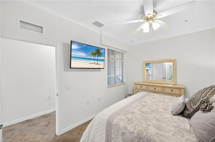 Bedroom featuring ornamental molding and a ceiling fan