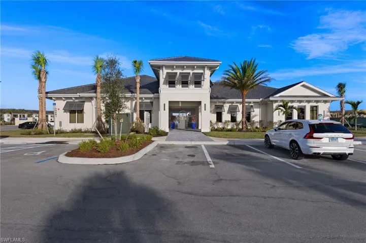 View of property featuring uncovered parking