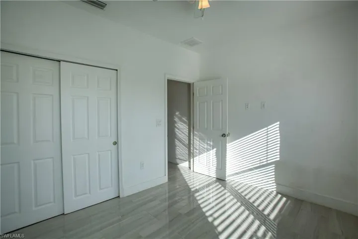 Unfurnished bedroom with a closet and baseboards