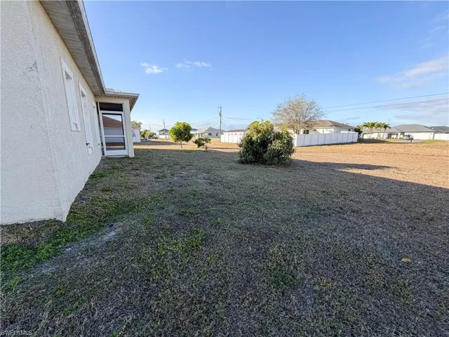 View of yard featuring a residential view and a sunroom