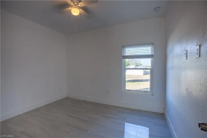 Empty room featuring wood finished floors and ceiling fan