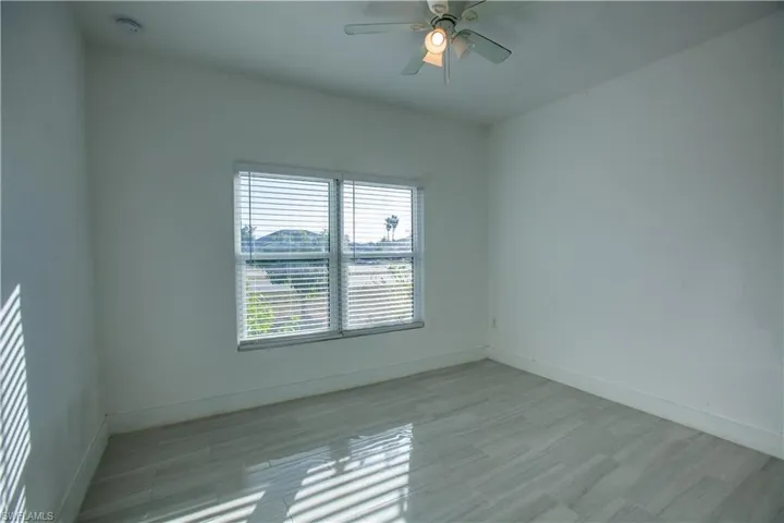 Spare room with ceiling fan and light wood finished floors