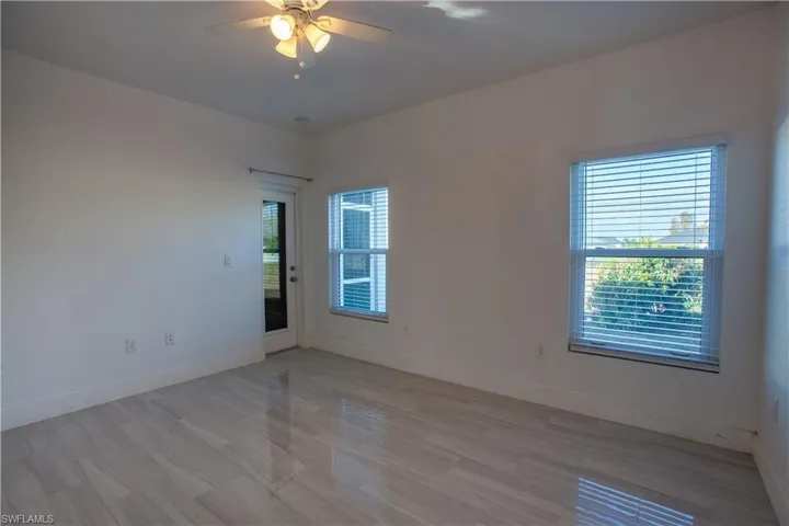 Empty room with ceiling fan and wood finished floors