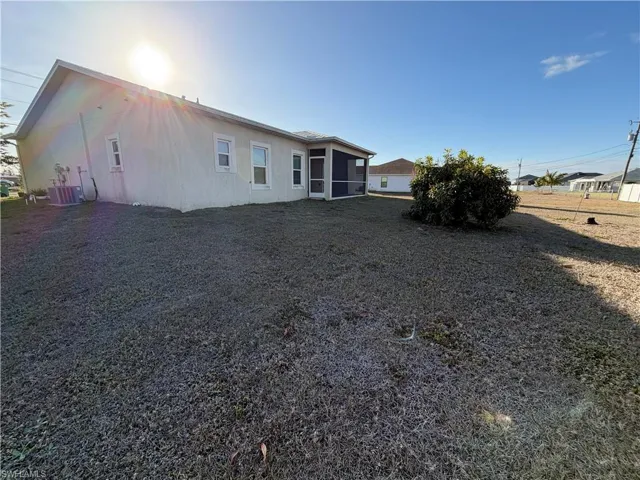Rear view of property featuring a sunroom