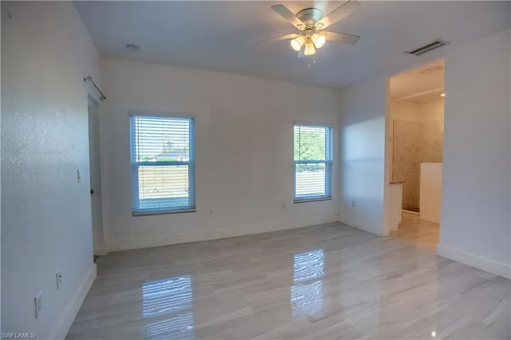Unfurnished room featuring baseboards and ceiling fan