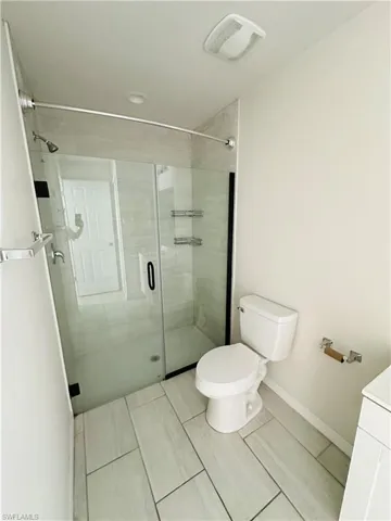 Full bathroom featuring a shower stall and vanity